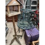 A green metal garden table and 2 chairs together with a wooden bird table/feeder