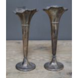A pair of hallmarked silver vases, height 21cm, as found.