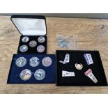 Two sets of Michael Jackson commemorative coins, a London 2012 olympic badge set and a bag of