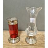 A cranberry glass sugar sifter with silver top and base together with a bud glass vase with silver