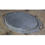 An Edwardian silver tray, oval form with twin handles, gadrooned border and engraved floral