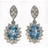 A pair of aquamarine and diamond earrings, each oval mixed cut aquamarine weighing approx. 0.70cts