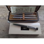 Vintage pens and pencils comprising a brushed steel Parker trio comprising fountain, ballpoint and
