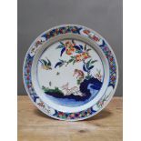A Chinese Wucai porcelain dish, over enamels depicting a monkey, deer, bird and tree, six