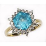 A blue topaz and diamond cluster ring, the central hexagonal cut stone measuring approx. 8mm x 9mm x