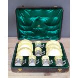 A Victorian cased set of six silver mounted coffee cans and saucers, William Comyns, Birmingham