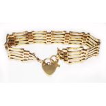 A hallmarked 9ct gold gate bracelet with heart shaped padlock clasp, length 16cm, wt. 10.6g.