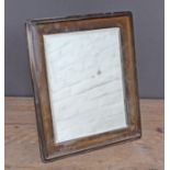 A hallmarked silver mirror, oak backing, 28cm x 33cm.