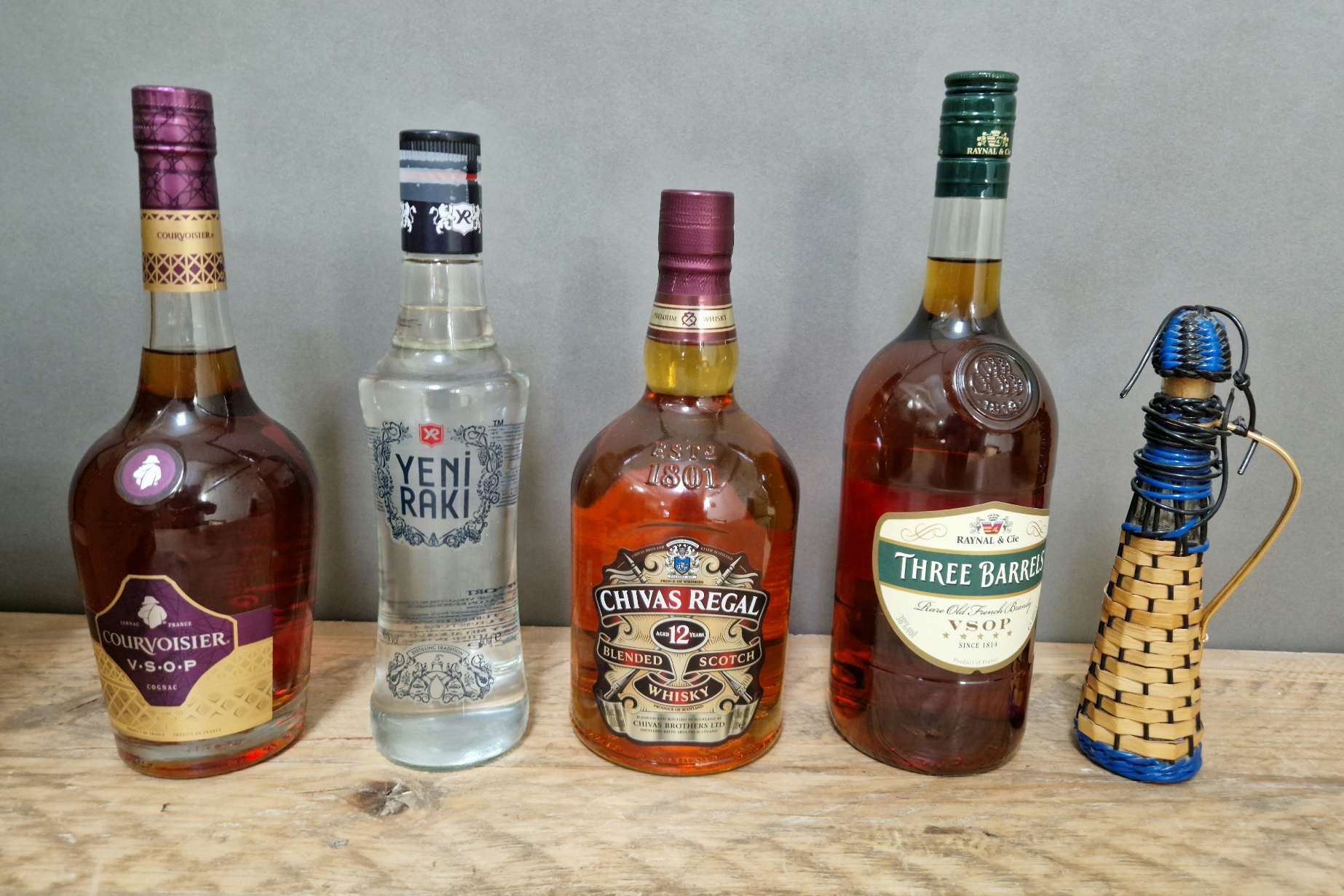 Five bottles of spirits; Chivas Regal 12 year old whiskey, Three Barrels brandy, Courvoisier brandy,