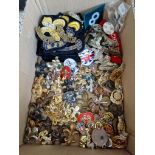 A collection of cap badges and other related items including WW1 and WW2 examples, patches, etc,