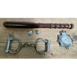 A wooden truncheon, West Yorkshire police badge and a pair of early 20th century handcuffs