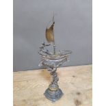 A silver plated pedestal dish formed as a cherub holding up a sail boat, height 48cm.