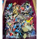 A box of assorted vintage toy soldiers