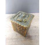 A cast brass tea caddy, height 12cm.