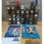 A large box containing Star Wars helmet collection and a reproduction metal Star Wars poster.