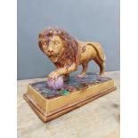 A 19th century Majolica lion on plinth, length 36cm, as found.