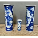 A pair of tall blue and white Oriental (Chinese) vases (both as found) and a similar small one.