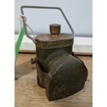 A war time issue battery bicycle lamp with hooded beam and army green paintwork, marked '