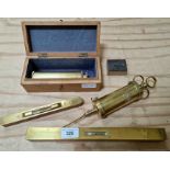 A collection of various old tools including two wood and brass spirit levels, a 19th century brass