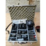 A Nikon camera and a Minolta camera with case and various accessories including lenses etc.