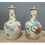 A pair of Japanese crackled and hand painted vases with lids.
