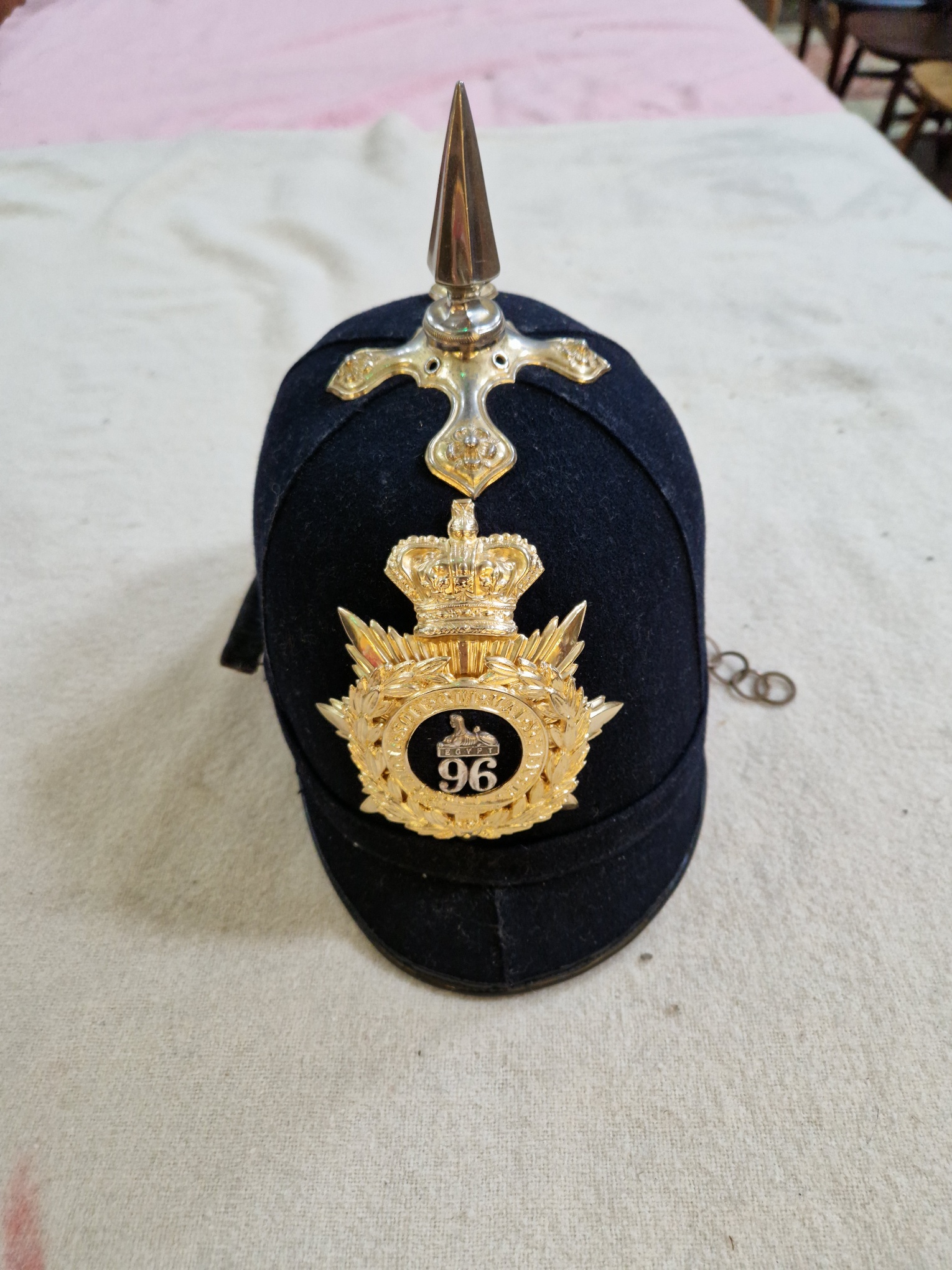 A group of four military helmets to include two Manchester Regiment Officer's blue cloth helmets, - Image 11 of 13