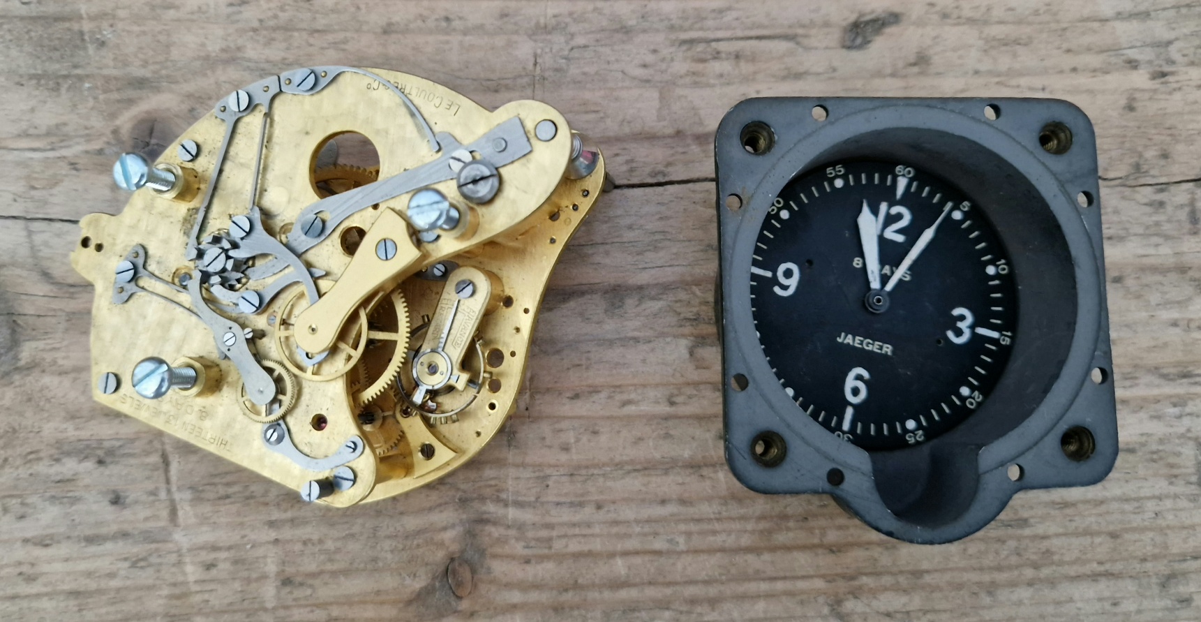 A Jaeger Le Coultre WWII cockpit clock movement together with a Jaeger cockpit clock face.