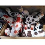 A box of assorted Staffordshire pot dogs.