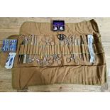 A collection of vintage surgical tools together with a pair of vintage glass eyes in box.