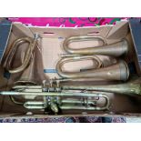 A box containing three copper & brass bugles and a Besson trumpet