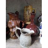 A mixed lot of 19th century ceramics comprising a salt glazed toby jug, a pair of bottle vases,