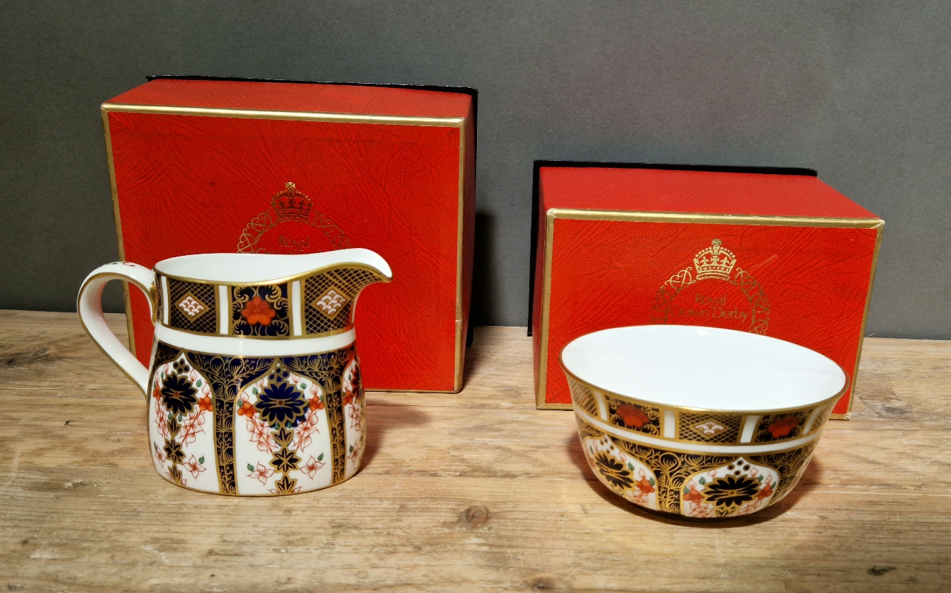 A Royal Crown Derby 1128 Imari sugar bowl & cream jug, with boxes.