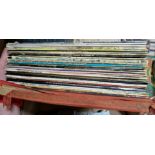 A box of vinyl LP records, various atrists and genres including The Jam, War of the Worlds, Abba,