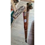 A walking stick with antler handle and white metal mount together with a brass dog's head with