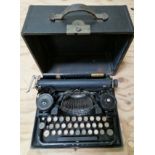 An early 20th century cased Underwood manual typewriter.