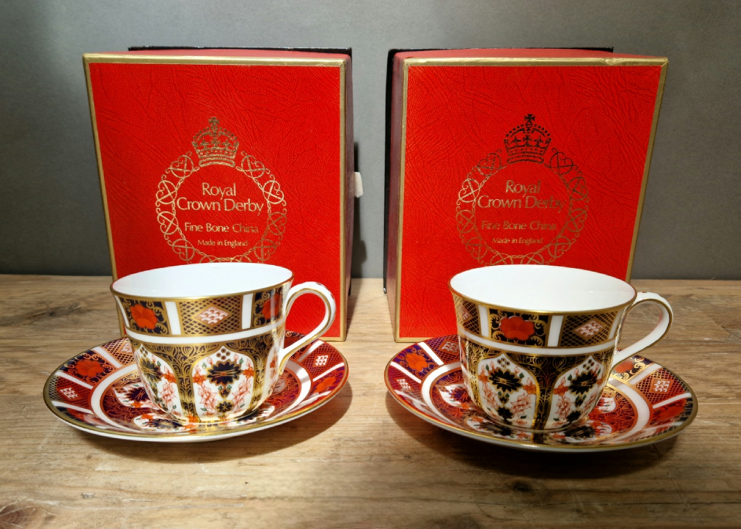 A set of two Royal Crown Derby 1128 Imari teacups and saucers, with boxes.