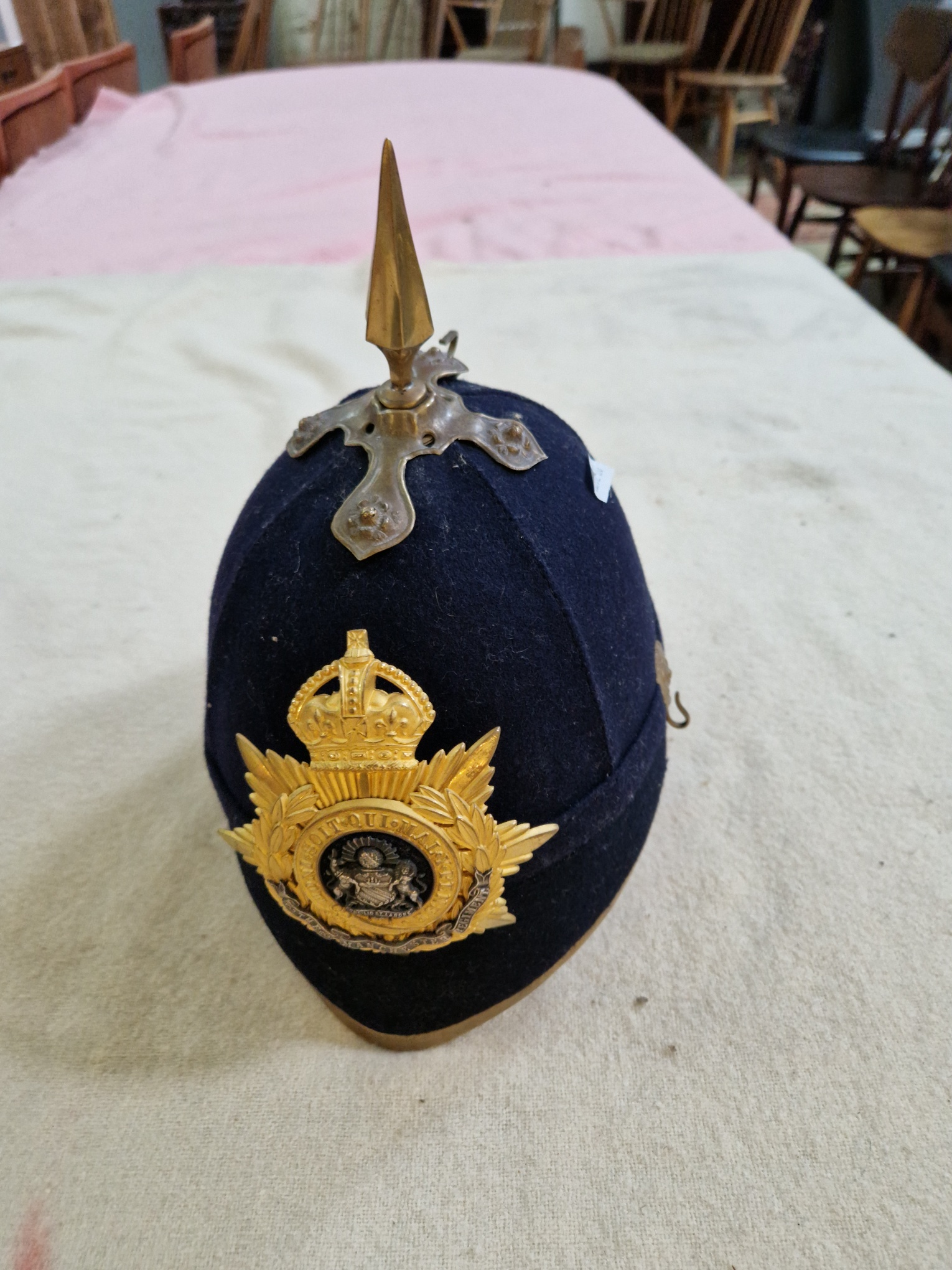 A group of four military helmets to include two Manchester Regiment Officer's blue cloth helmets, - Image 2 of 13