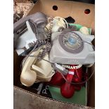 A collection of six vintage telephones including, wall phone, button phone and dial phones.