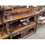 A late Victorian carved oak buffet sideboard with Green Man handles.