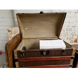 A domed trunk and contents including a tray, a wash board, 1930s china, meat plates, dishes.