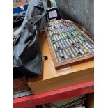 Two boxes of artist's pastels and a metal easel.