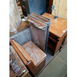 An oak pew with microphone stand.