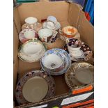 A box of antique cups and saucers.