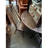 An Ercol drop leaf dining table and four Ercol 'Goldsmith' chairs.