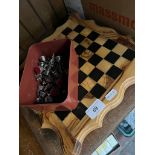 A wooden chess board with two lots of pieces.