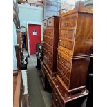 Various items of yew wood furniture; a chest of drawers, pedestal desk/dressing table, triple mirror