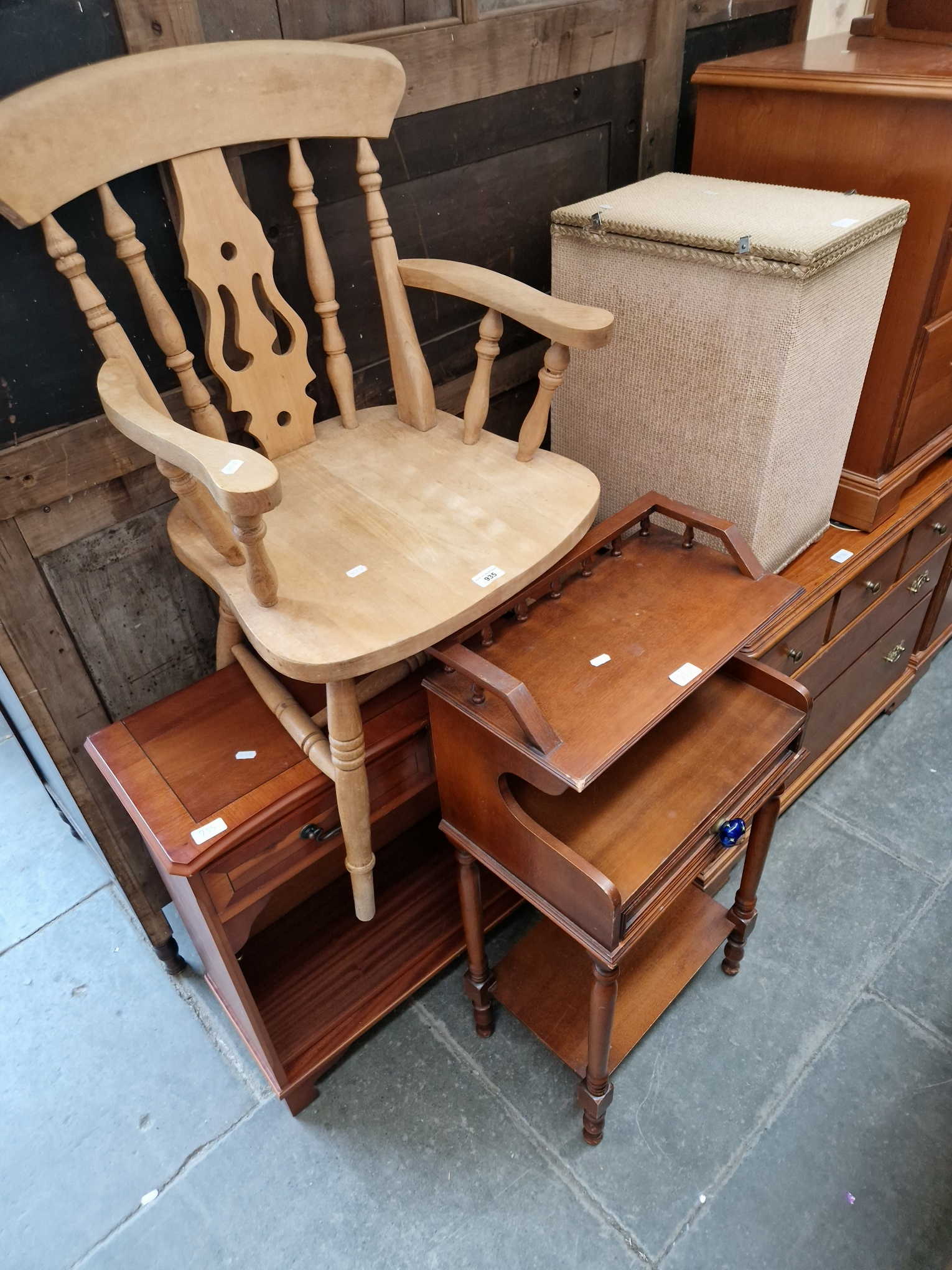 Four pieces of furniture; a beech carver chair, a yew wood side cabinet, a Lloyd Loom linen basket