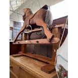 A carved pine rocking horse, length 96.5cm, height to saddle 70cm.