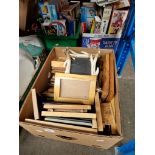 A box of assorted photograph frames.