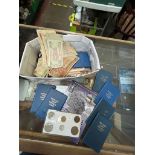 A box of world coins and banknotes to include sets etc.
